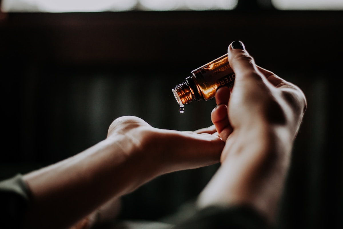Essential oil drop in warm evening light representing a calming bedtime wind-down ritual