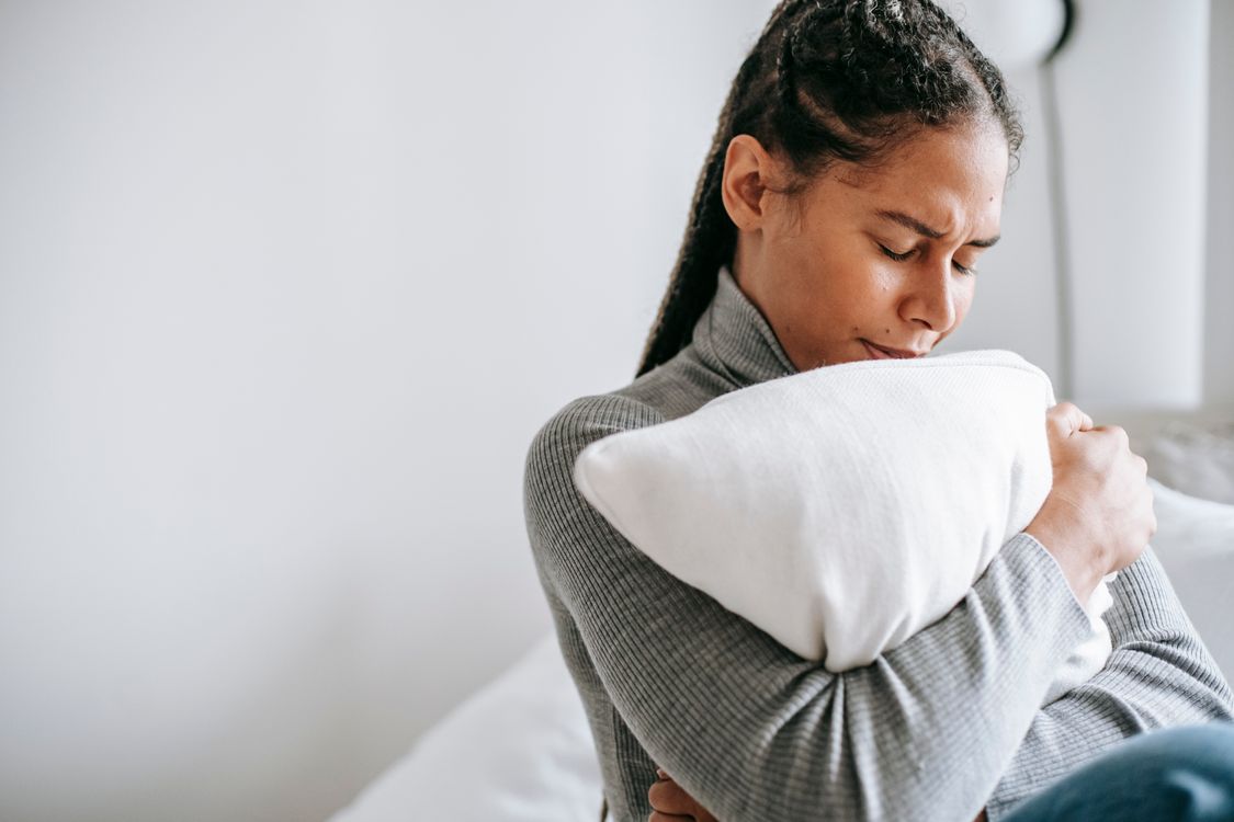 Person stretching gently in bed after waking up