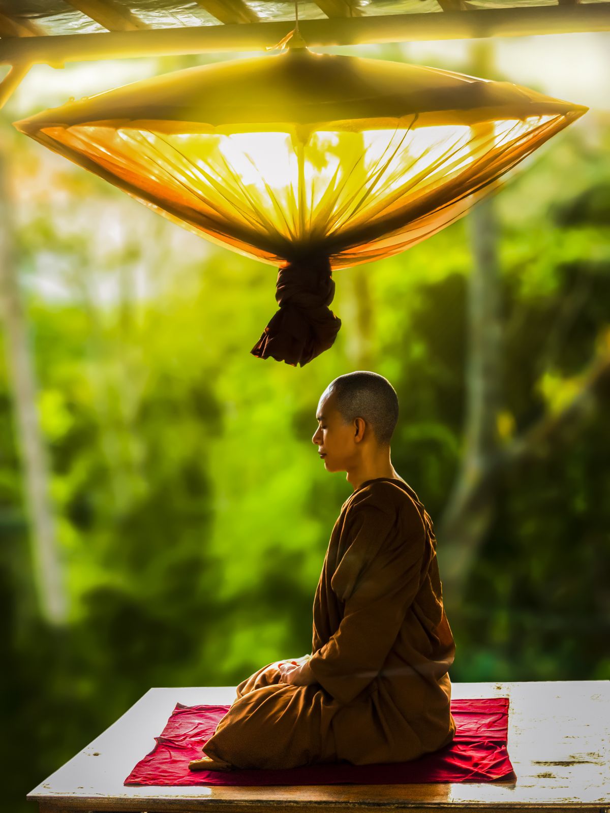 Buddhist monk meditating outdoors showing ancient roots of equal breathing