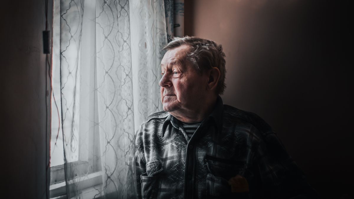Elderly man gazing calmly out a window showing box breathing suits all ages